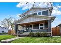 Inviting two-story home with a covered front porch featuring stylish wood accents at 827 E Minnesota St, Indianapolis, IN 46203