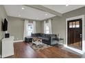 Cozy living room featuring a comfortable gray sectional and hardwood floors at 827 E Minnesota St, Indianapolis, IN 46203
