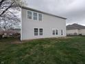 Exterior rear view of a two-story home with vinyl siding and a spacious backyard at 8404 Alcona Dr, Indianapolis, IN 46237