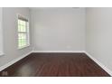 Minimalist bedroom features dark hardwood floors, neutral paint, natural light, and a modern aesthetic at 8404 Alcona Dr, Indianapolis, IN 46237