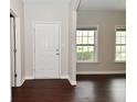 Bright entryway with dark floors, white trim, a neutral color scheme, and natural light from multiple windows at 8404 Alcona Dr, Indianapolis, IN 46237