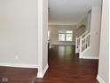 The living room showcases dark hardwood floors, neutral paint, and plenty of natural light from the windows at 8404 Alcona Dr, Indianapolis, IN 46237