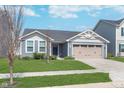 Attractive single-Gathering home with a blue exterior, a green lawn, and an attached two-car garage at 846 Sunchaser Rd, Lebanon, IN 46052
