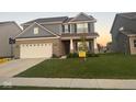 Charming two-story home with a well-manicured lawn and attached two car garage at 9851 Pica Dr, Fishers, IN 46040