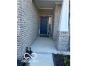 Inviting front entrance with a welcoming 'WELCOME' sign and a charming decor at 9851 Pica Dr, Fishers, IN 46040