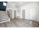 Bright foyer with wood-look flooring, stylish storage, and a modern front door at 1038 St Peter St, Indianapolis, IN 46203