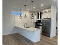 Bright kitchen with white cabinets, stainless appliances, and a marble countertop island at 1038 St Peter St, Indianapolis, IN 46203
