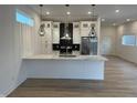Bright kitchen with white cabinets, stainless appliances, and a marble countertop island at 1038 St Peter St, Indianapolis, IN 46203