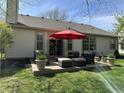 An outdoor patio set creates a backyard oasis, perfect for relaxing and entertaining at 10799 Belair Dr, Carmel, IN 46280