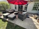 Relax in the backyard on this stamped concrete patio with comfortable wicker outdoor furniture at 10799 Belair Dr, Carmel, IN 46280