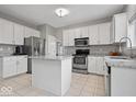 Modern kitchen featuring white cabinets, stainless steel appliances, granite countertops, and a convenient center island at 10889 Weston Dr, Carmel, IN 46032