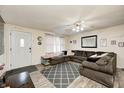Spacious living room featuring a large sectional, ceiling fan, and neutral color palette at 11416 Stoeppelwerth Dr, Indianapolis, IN 46229