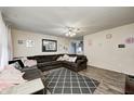 Cozy living room with a large sectional sofa, ceiling fan, and stylish decor at 11416 Stoeppelwerth Dr, Indianapolis, IN 46229