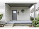 Inviting covered front porch with classic architectural details, offering a welcoming entrance to the home at 126 S 3Rd Ave, Beech Grove, IN 46107