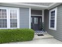 Elegant front entry featuring sidelights, a decorative door, and a striped welcome mat at 13151 Walters Rd, Martinsville, IN 46151