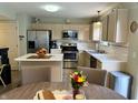 Modern kitchen featuring stainless steel appliances, light wood cabinets and an island at 13993 Whittier Dr, Fishers, IN 46038