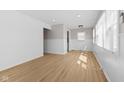 Bright living room with fresh white paint, contemporary light fixture, and sleek, light-colored wood flooring at 1836 N Riley Ave, Indianapolis, IN 46218