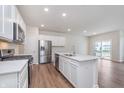 Bright and spacious kitchen featuring white cabinets, stainless steel appliances, and a quartz countertop island at 18769 Moray St, Westfield, IN 46074