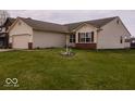 Well-kept single-Gathering home with a two-car garage, complemented by a lush green lawn at 2179 W Van Arsdall Ct, Columbus, IN 47201
