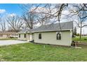Green sided house with a gravel driveway at 2264 Walnut W St, Greenfield, IN 46140