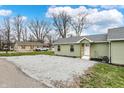 Green sided house with gravel driveway and simple landscaping at 2264 Walnut W St, Greenfield, IN 46140