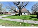 Attractive single-Gathering home with lush green lawn, mature trees, and charming architectural details at 260 Christina Dr, Whiteland, IN 46184