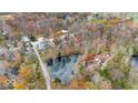 Aerial view of neighborhood with lake and wooded areas at 268 E Hoover Dr, Princess Lakes, IN 46164