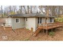 Exterior view of home, showing the wooden deck and easy access to the surrounding nature at 268 E Hoover Dr, Princess Lakes, IN 46164