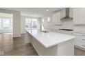 Bright kitchen features a large island with a white countertop, stainless steel appliances, and light wood-look floors at 2766 Ruffian Dr, Westfield, IN 46074