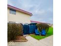 Exterior of home with fenced in back yard and two blue chairs at 2804 Paso Del Norte Dr, Indianapolis, IN 46227