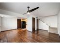 A bright living room featuring wood floors, a ceiling fan, and a staircase at 2804 Paso Del Norte Dr, Indianapolis, IN 46227