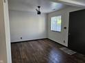 Bright living room featuring hardwood floors, a ceiling fan, and a large window at 2804 Paso Del Norte Dr, Indianapolis, IN 46227
