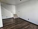 Bright living room featuring hardwood floors and a staircase with a white railing at 2804 Paso Del Norte Dr, Indianapolis, IN 46227