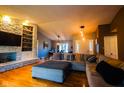 Bright open-concept living room flows into dining area, featuring a stone fireplace and modern finishes at 3037 Santiago Dr, Greenwood, IN 46143
