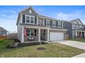 Beautiful two-story home with a front porch swing and manicured lawn at 315 Limerick Ln, Pendleton, IN 46064