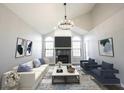 Bright living room featuring vaulted ceilings, a cozy fireplace, neutral tones, and stylish decor for comfortable living at 3260 Eddy Ct, Indianapolis, IN 46214