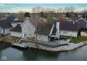 Waterfront home with deck, gazebo, and hot tub overlooking calm water, providing serene outdoor living at 3260 Eddy Ct, Indianapolis, IN 46214