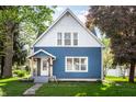 Charming two-story home with a blue exterior, well-maintained lawn, and inviting front porch at 421 S East St, Plainfield, IN 46168