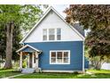 Charming two-story home with a blue exterior, well-maintained lawn, and inviting front porch at 421 S East St, Plainfield, IN 46168