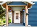 Inviting front porch with hanging flower baskets, stone accents, and updated front door at 421 S East St, Plainfield, IN 46168