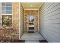 Inviting front entryway with brick accents, stylish door with wreath, and neutral siding at 5387 Crowley Pkwy, Whitestown, IN 46075