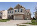 Attractive two-story house showcasing a spacious driveway, garage, and well-maintained lawn at 5387 Crowley Pkwy, Whitestown, IN 46075