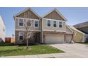 Beautiful two-story home with well-manicured lawn, two-car garage, and a basketball hoop at 5387 Crowley Pkwy, Whitestown, IN 46075