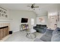 Cozy living room with a fireplace, modern floors, and comfortable seating at 5541 Fair Ridge Pl, Indianapolis, IN 46221