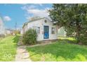 Charming home with a quaint front yard and blue door, under a sunny sky at 555 Leeds Ave, Indianapolis, IN 46203