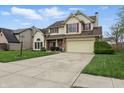 Traditional two-story home boasting a well-kept lawn, attached garage, and a wide concrete driveway at 5710 Dapple Trce, Indianapolis, IN 46228