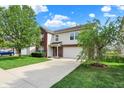Exterior showcasing a two-story home with an attached two-car garage, lawn, and concrete driveway at 5861 W Deerview Bnd, McCordsville, IN 46055