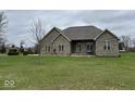 Classic brick house with a well-maintained lawn and a basketball hoop at 6089 W Hellis Dr, Muncie, IN 47304