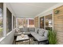 Relaxing screened porch with stone exterior, comfortable seating and neutral decor at 6120 Norwaldo Ave, Indianapolis, IN 46220