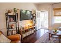 Comfortable living room with dark wood floors, stylish decor, and an open doorway to the sunroom at 619 Kessler Blvd E Dr, Indianapolis, IN 46220